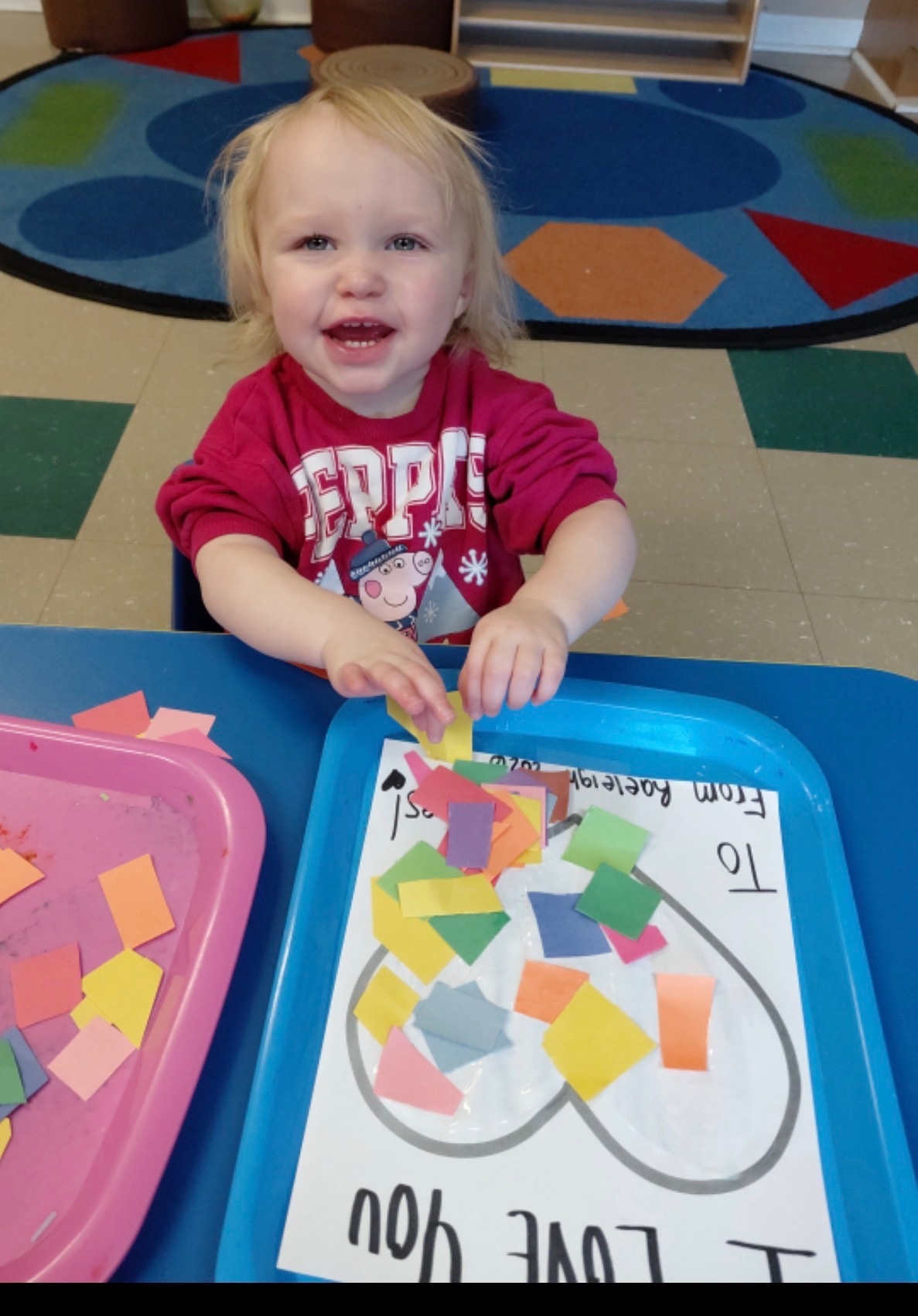 Child smiling during a craft activity at The Learning Tree for Children