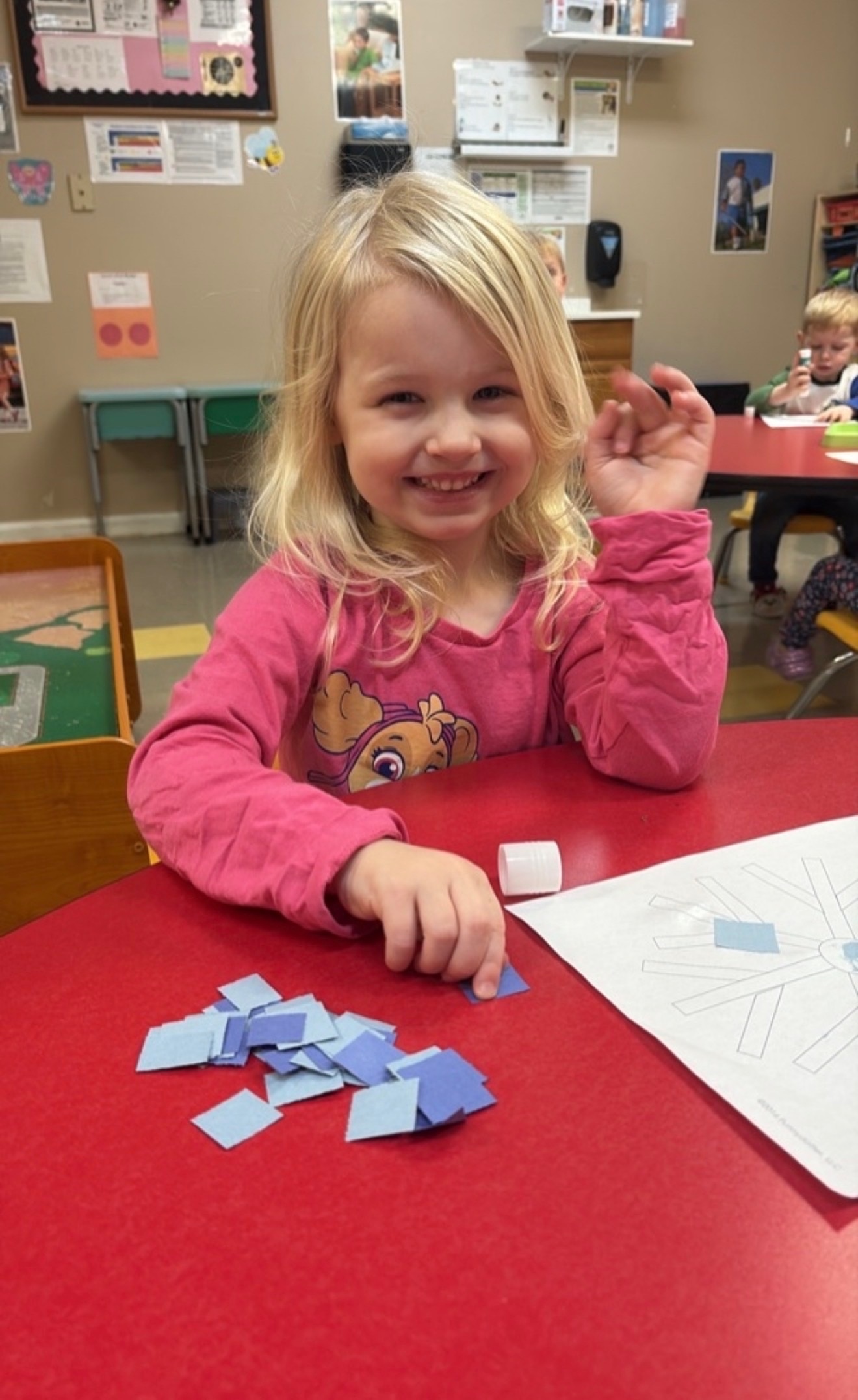 Child smiling during a classroom activity